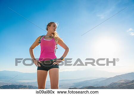 Woman taking break on mountain, Joshua Tree National Park, California, US View Large Photo Image Stock Photo - Woman taking break on mountain, Joshua Tree National Park, California, US. Fotosearch