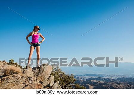 Stock Photo - Woman taking break on mountain, Joshua Tree National Park, California, US. Fotosearch