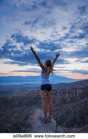 Woman taking break on mountain, Joshua Tree National Park, California, US View Large Photo Image Stock Photograph - Woman taking break on mountain, Joshua Tree National Park, California, US. Fotosearch