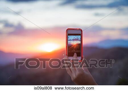 Woman taking photo of mountain, Joshua Tree National Park, California, US View Large Photo Image Stock Photo - Woman taking photo of mountain, Joshua Tree National Park, California, US. Fotosearch