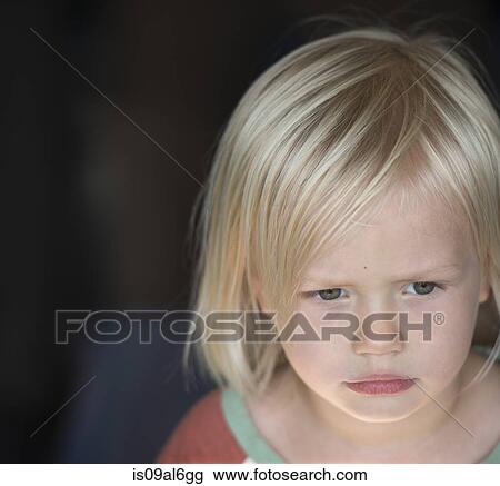 Stock Image - Young boy with blonde hair, portrait. Fotosearch