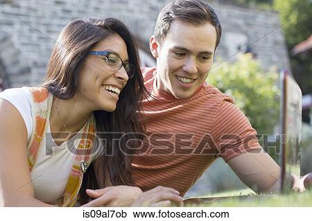 Young couple using laptop View Large Photo Image Stock Image - Young couple using laptop. Fotosearch