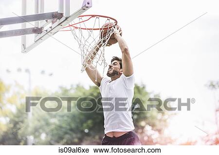 Young male basketball player jumping with ball to score View Large Photo Image Stock Image - Young male basketball player jumping with ball to score. Fotosearch