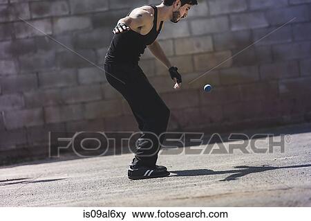 Young male handball player hitting ball against wall View Large Photo Image Stock Photo - Young male handball player hitting ball against wall. Fotosearch