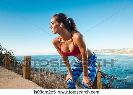 Young woman doing stretches by sea View Large Photo Image Stock Photography - Young woman doing stretches by sea. Fotosearch