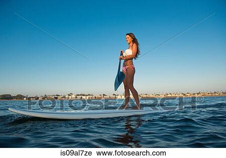 Young woman stand up paddleboarding, Mission Bay, San Diego, California, USA View Large Photo Image Stock Image - Young woman stand up paddleboarding, Mission Bay, San Diego, California, USA. Fotosearch