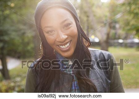 Young woman with wide smile in park View Large Photo Image Stock Image - Young woman with wide smile in park. Fotosearch