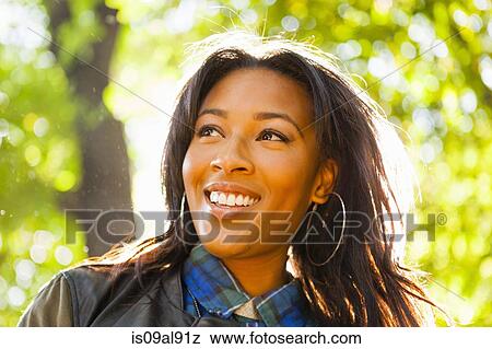 Young woman with wide smile in park View Large Photo Image Stock Photo - Young woman with wide smile in park. Fotosearch
