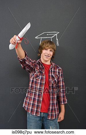 Stock Photograph - A boy holding a scroll and a chalk mortar board. Fotosearch