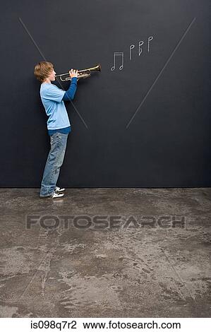 Stock Image - A boy playing a trumpet. Fotosearch