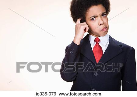 Stock Photo - A boy scratching his head. Fotosearch