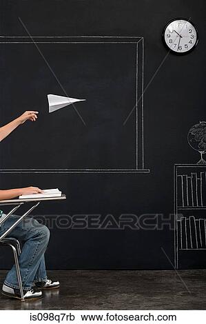 A boy throwing a paper airplane View Large Photo Image Stock Image - A boy throwing a paper airplane. Fotosearch