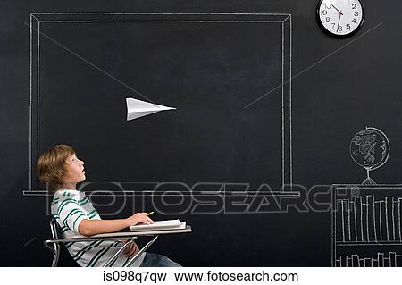 Stock Photo - A boy with a paper airplane over his head. Fotosearch