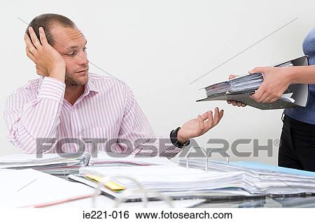 A businessman being given more work View Large Photo Image Stock Photograph - A businessman being given more work. Fotosearch