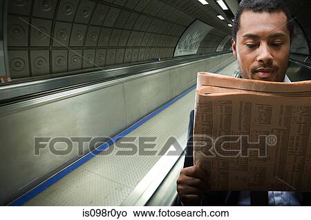 A businessman reading a newspaper View Large Photo Image Picture - A businessman reading a newspaper. Fotosearch