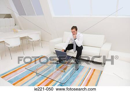 A businessman using a laptop View Large Photo Image Stock Image - A businessman using a laptop. Fotosearch