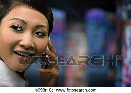 A businesswoman using a cell phone View Large Photo Image Stock Image - A businesswoman using a cell phone. Fotosearch