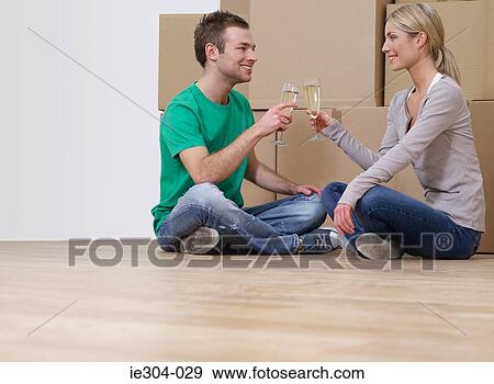 A couple having champagne in their new home View Large Photo Image Stock Photo - A couple having champagne in their new home. Fotosearch