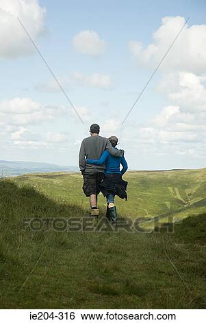 Stock Photograph - A couple hiking. Fotosearch