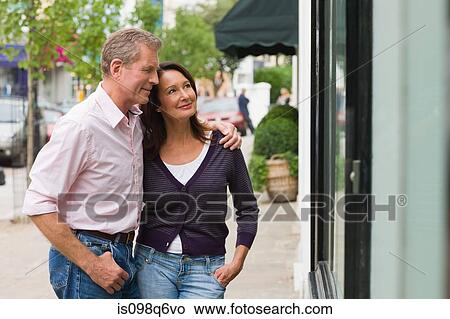 A couple looking in a shop window View Large Photo Image Picture - A couple looking in a shop window. Fotosearch