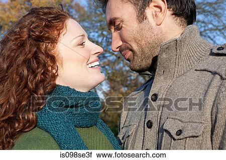 Stock Image - A couple smiling face to face. Fotosearch
