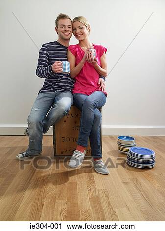 A couple taking a break in their new home View Large Photo Image Stock Image - A couple taking a break in their new home. Fotosearch