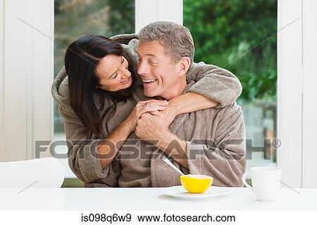 Stock Photo - A couple together at breakfast. Fotosearch
