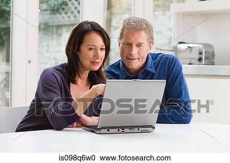 Stock Image - A couple using a laptop. Fotosearch