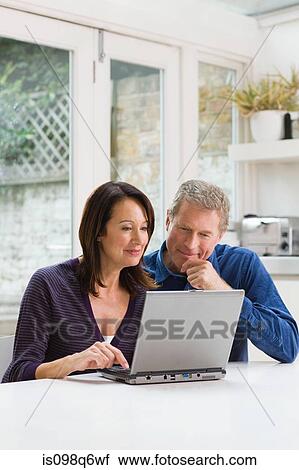 Stock Image - A couple using a laptop. Fotosearch