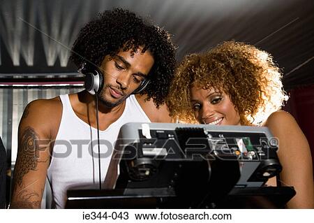 A dj and a young woman View Large Photo Image Stock Image - A dj and a young woman. Fotosearch