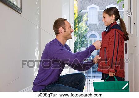 A father doing up his daughters coat View Large Photo Image Stock Photography - A father doing up his daughters coat. Fotosearch