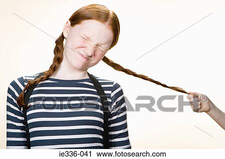 A girl having her pigtail pulled View Large Photo Image Stock Image - A girl having her pigtail pulled. Fotosearch