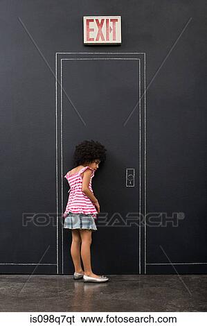 Stock Photograph - A girl listening by a door. Fotosearch