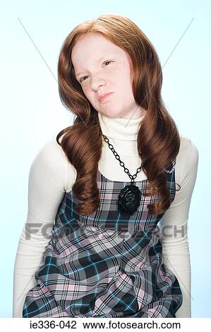 Stock Image - A girl making faces. Fotosearch
