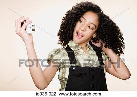 A girl photographing herself View Large Photo Image Stock Image - A girl photographing herself. Fotosearch