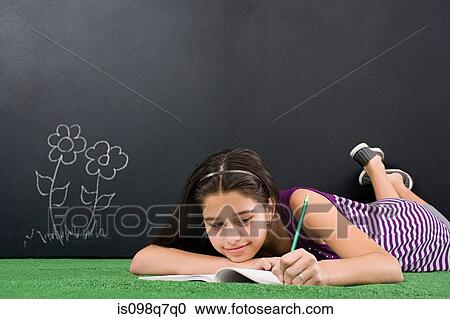 A girl writing in notebook View Large Photo Image Stock Image - A girl writing in notebook. Fotosearch