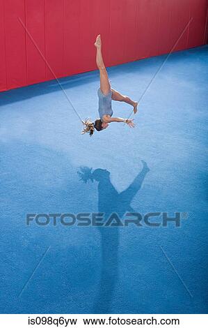 A gymnast doing floor exercises View Large Photo Image Stock Photo - A gymnast doing floor exercises. Fotosearch