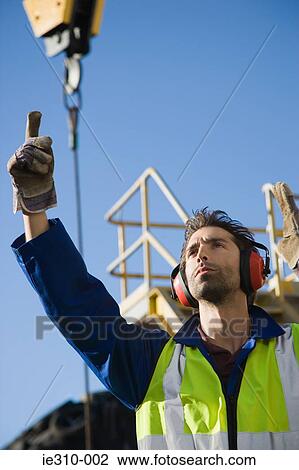 A harbour worker pointing View Large Photo Image Stock Image - A harbour worker pointing. Fotosearch