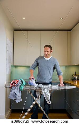 A house husband ironing View Large Photo Image Stock Photography - A house husband ironing. Fotosearch