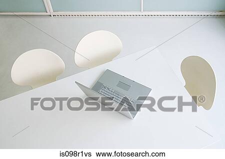 Stock Photograph - A laptop on a table in an office. Fotosearch