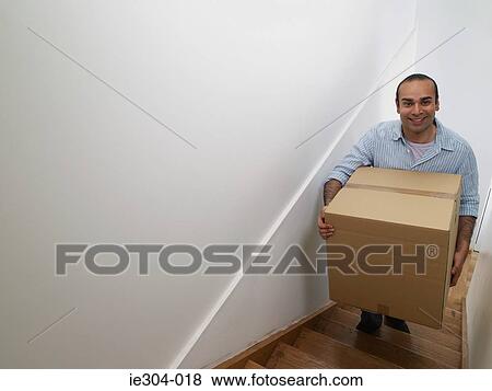 A man carrying a box View Large Photo Image Stock Photo - A man carrying a box. Fotosearch