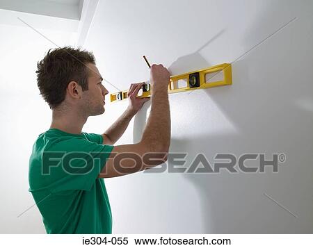 A man using a spirit level View Large Photo Image Stock Photography - A man using a spirit level. Fotosearch