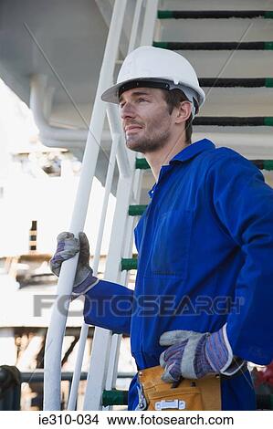 Picture - A manual worker wearing a hard hat. Fotosearch