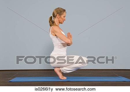 A mature woman in a yoga position View Large Photo Image Stock Photo - A mature woman in a yoga position. Fotosearch