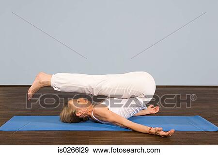 A mature woman in a yoga position View Large Photo Image Stock Photo - A mature woman in a yoga position. Fotosearch