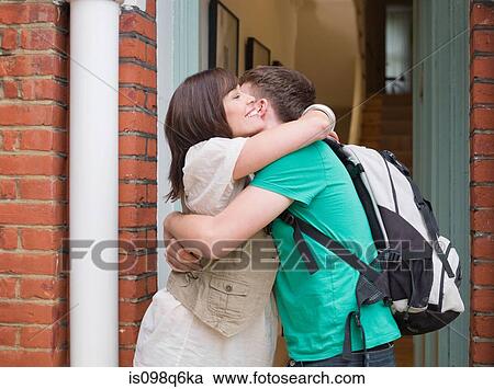 Stock Image - A mother hugging her son. Fotosearch