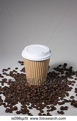 A paper cup on coffee beans View Large Photo Image Stock Photograph - A paper cup on coffee beans. Fotosearch