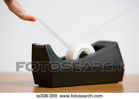 A person holding adhesive tape View Large Photo Image Stock Photo - A person holding adhesive tape. Fotosearch