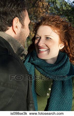 Stock Image - A smiling woman looking at her partner. Fotosearch