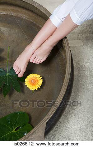 A woman bathing her feet View Large Photo Image Stock Image - A woman bathing her feet. Fotosearch